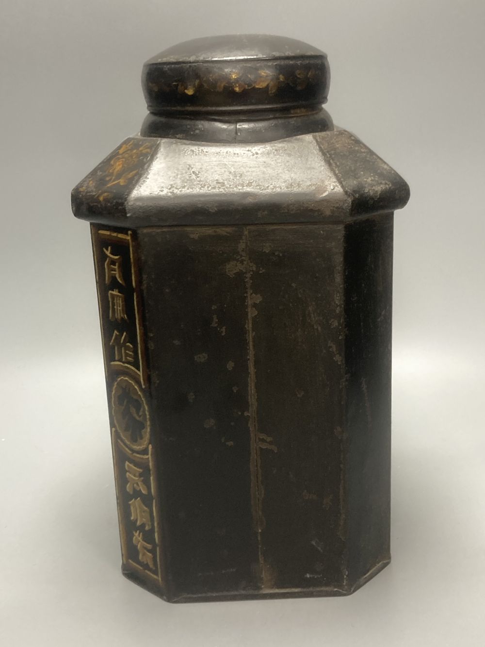 A 19th century toleware octagonal tea canister, J. Newman, Dublin, painted with flowers and Chinese script, 36cm